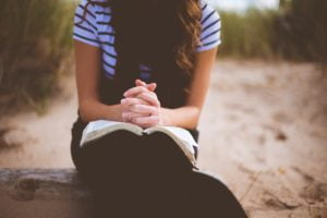 Praying over Open Bible